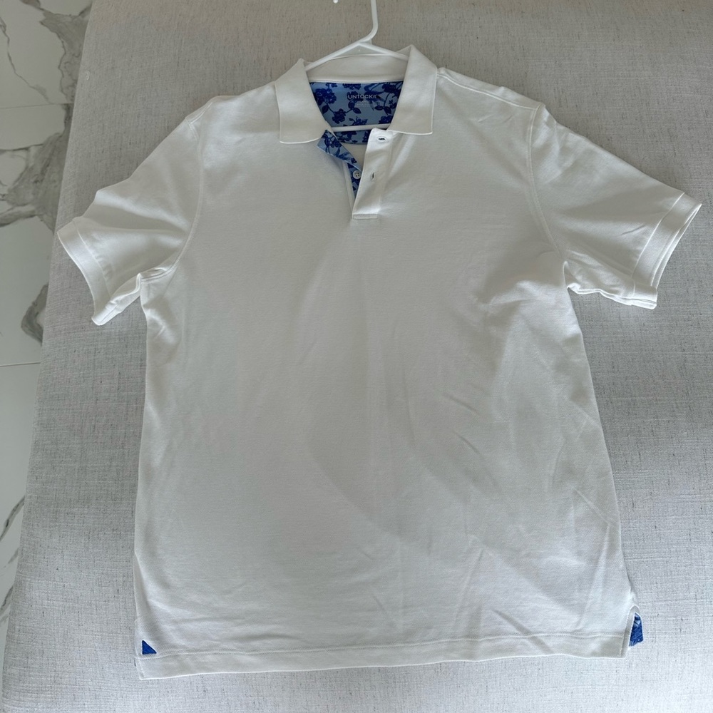 White UNTUCKit polo with blue floral detail
